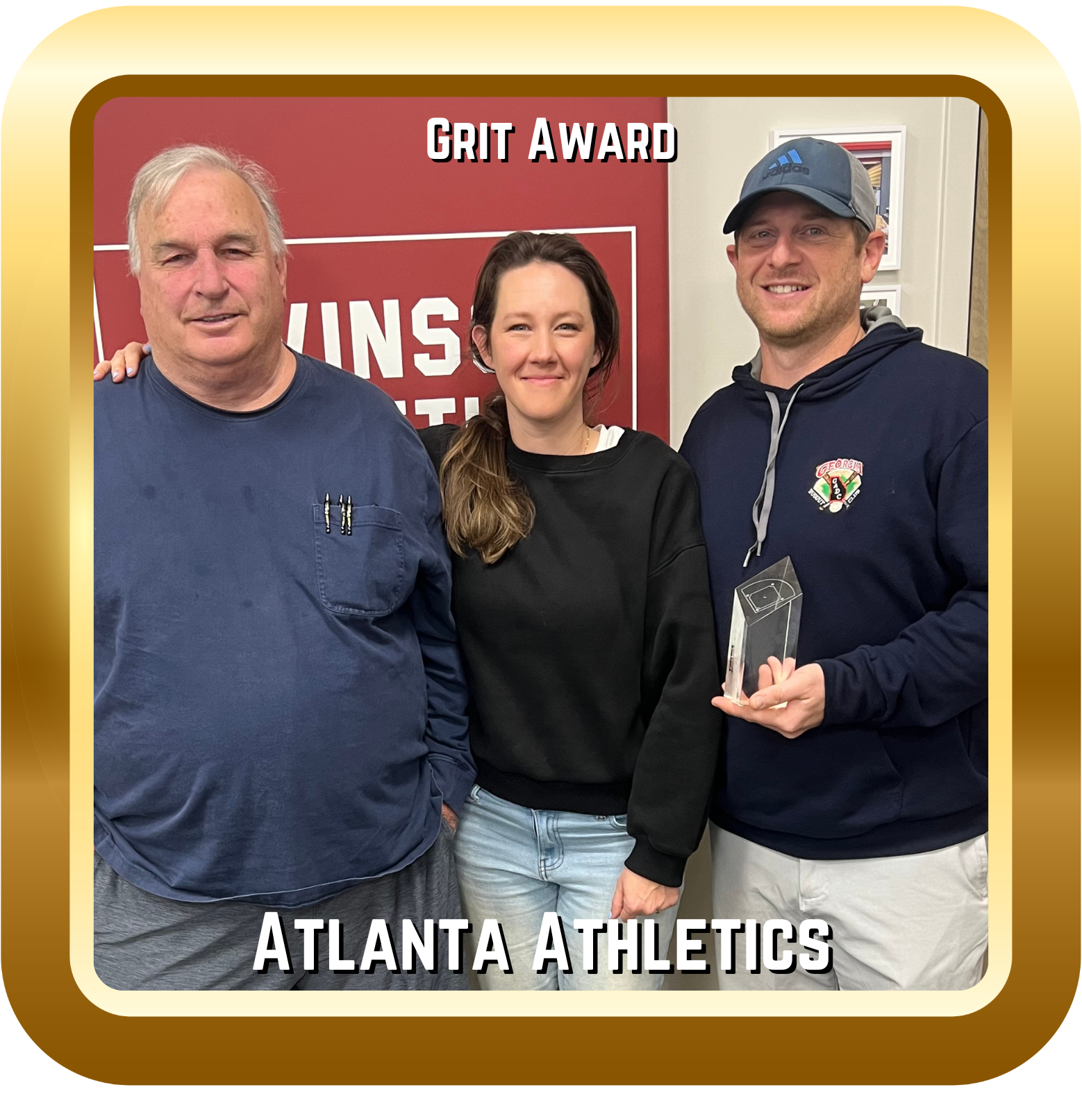 Image of two men and a woman with a Grit Award.
