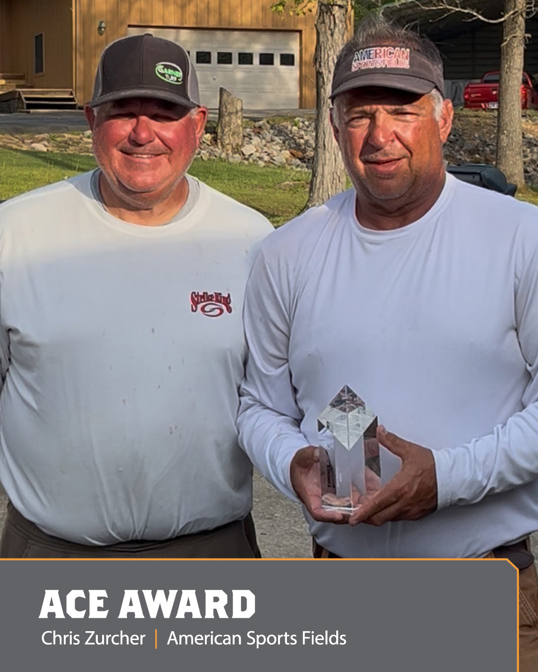 Image of two men holding an Ace Award.