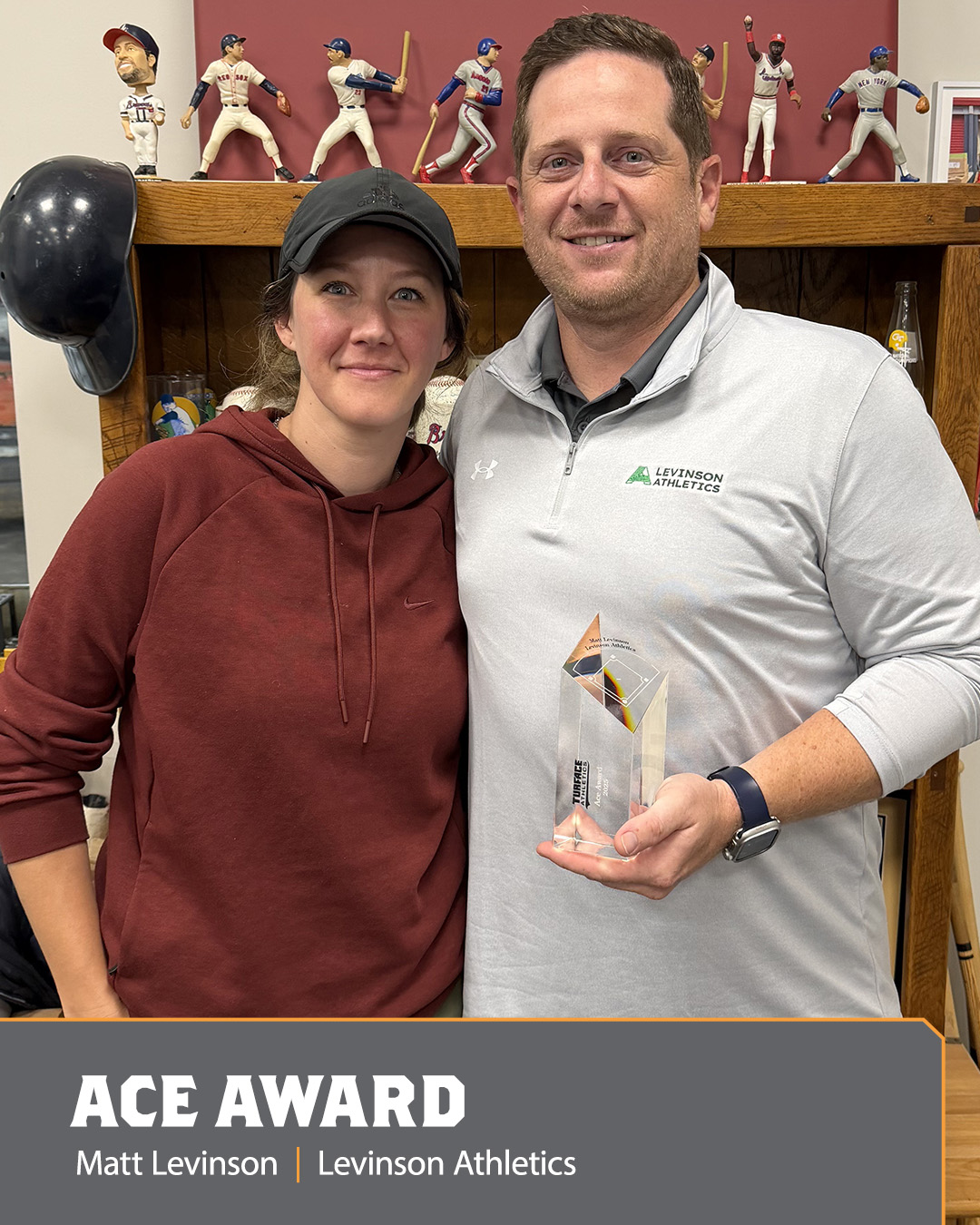 Image of a man and woman holding an Ace Award.