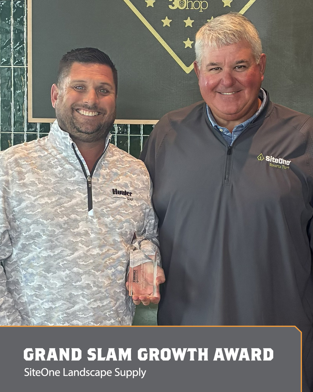 Image of two men holding an Ace Award.