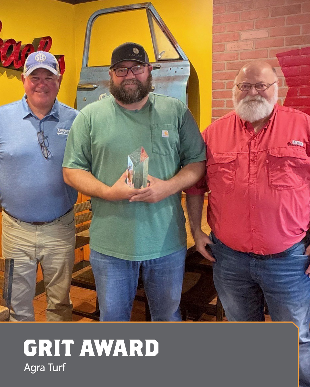 Image of three men holding an Ace Award.