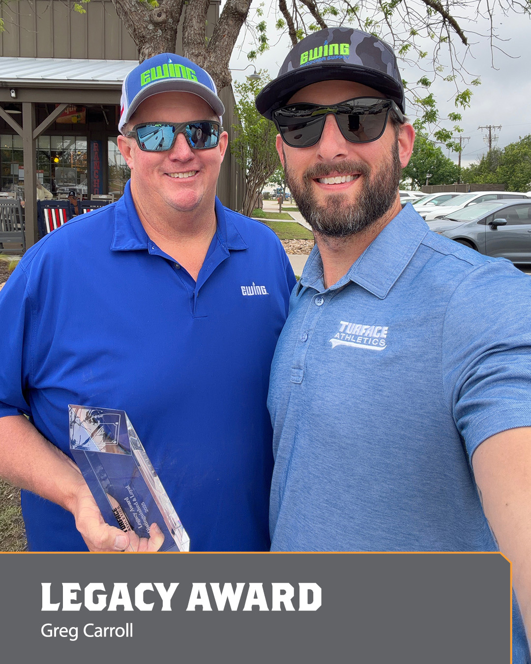 Image of two men holding an Ace Award.