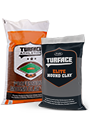 Two construction-material bags side by side: an orange-and-white bag labeled “Lime Mortar” and a black bag labeled “SURFACE FLX,” both shown against a light background.